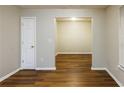 A living room features hardwood floors and an open doorway to another room at 612 Stadler Pointe, Mcdonough, GA 30253