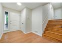 Bright foyer with hardwood floors, white trim, and staircase leading to upper level at 2940 Leah Ln, Douglasville, GA 30135