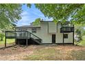 The back exterior features a spacious deck and a second-story balcony overlooking a private yard at 2940 Leah Ln, Douglasville, GA 30135