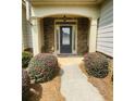 Inviting front door framed by stone accents and manicured bushes creating a warm welcome at 4357 Kershaw Dr, Snellville, GA 30039