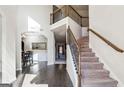 Grand foyer with hardwood floors, staircase, and a view into the formal dining room at 4357 Kershaw Dr, Snellville, GA 30039