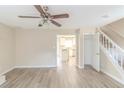 Spacious living room with ceiling fan and view to the kitchen and staircase at 116 Black Oak Ct, Stockbridge, GA 30281