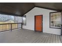 Charming front porch featuring a modern orange front door and dark trim windows at 391 S Bend Se Ave, Atlanta, GA 30315