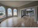 Sunlit living room with large windows, hardwood floors, and elegant trim work at 7910 Tintern Trce, Duluth, GA 30097