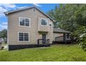 Exterior shot of home featuring a rear deck, a well-maintained lawn, and mature trees at 8740 Parliament Pl, Jonesboro, GA 30238