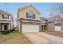 View of a two-story home with brick accents, attached garage, and inviting curb appeal at 11143 Aliyah Dr, Hampton, GA 30228