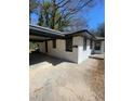 Charming exterior of a one-story house with a cozy carport and painted white brick at 1808 Brewer Sw Blvd, Atlanta, GA 30310