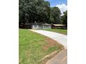 Inviting one story home with a long driveway and mature trees providing ample shade in the front yard at 1808 Brewer Sw Blvd, Atlanta, GA 30310