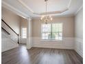Spacious dining area with hardwood floors, staircase, and natural light at 4950 Summersun Dr, Morrow, GA 30260