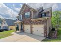 View of a beautiful two-story home with an attached two car garage at 4950 Summersun Dr, Morrow, GA 30260