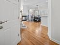 Bright entryway showcasing hardwood floors, a staircase, and an open view to the dining area at 8540 Hope Mews Ct, Atlanta, GA 30350