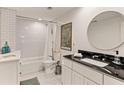 Elegant bathroom featuring subway tile shower, black granite countertops, and round mirror at 2316 Defoors Ferry Nw Rd, Atlanta, GA 30318