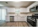 Modern kitchen showcasing stainless steel appliances, white cabinetry, and durable flooring at 3534 S Portsmouth Cir, Lithonia, GA 30038