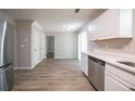 Well-lit kitchen providing stainless steel appliances, ample cabinetry, and resilient flooring at 3534 S Portsmouth Cir, Lithonia, GA 30038