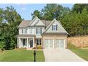 Inviting two-story home with a well-manicured lawn and two-car garage at 727 Crest Line W Trl, Powder Springs, GA 30127