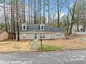 Charming home featuring gray siding, dormer windows, a well-maintained lawn, and easy street access at 806 Longfellow Ct, Stone Mountain, GA 30088