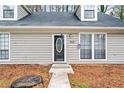 Close-up of the front door with decorative glass, siding, and windows at 806 Longfellow Ct, Stone Mountain, GA 30088
