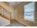 Bright entryway with hardwood floors, a staircase and a large window at 105 Bentley Place Way, Covington, GA 30016