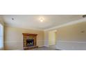 Cozy living room with a brick fireplace and neutral paint at 105 Bentley Place Way, Covington, GA 30016