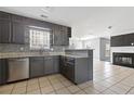 Kitchen featuring granite countertops, stainless steel dishwasher, gray cabinetry and mosaic backsplash at 1116 Oak Hollow Ln, Hampton, GA 30228