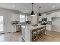 Bright kitchen with stainless steel appliances, granite countertops, and pendant lighting over island at 1238 Ainsworth Aly # 38, Sugar Hill, GA 30518