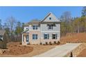 Inviting two-story home with a well-manicured lawn, complemented by a long driveway and a two-car garage at 723 Crest Line W Trl, Powder Springs, GA 30127