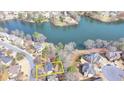 Aerial view of home showcasing lakefront lot, mature trees, and neighborhood at 10815 Donamere Dr, Johns Creek, GA 30022