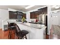 Modern kitchen with stainless steel appliances, granite countertops, and a breakfast bar at 209 Townview Dr, Woodstock, GA 30189