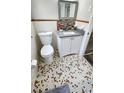 Compact bathroom featuring mosaic floors, a modern vanity, and coordinated decorative accents at 2653 Williamsburg Dr, Decatur, GA 30034