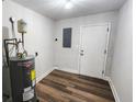Functional laundry room with modern laminate flooring, a water heater, and a convenient door at 2653 Williamsburg Dr, Decatur, GA 30034