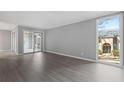 Bright living room showcasing wood floors, neutral walls, and a large window with views of the building exterior at 3236 Henderson Mill Rd, Atlanta, GA 30341