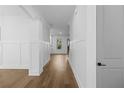 Bright hallway featuring hardwood floors, wainscoting and white trim at 3255 Hilltop Cir, Marietta, GA 30066