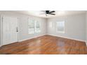 Bright living room featuring hardwood flooring, neutral walls, and ceiling fan at 60 Collins Rd, Carrollton, GA 30116