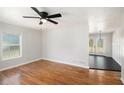 Bright living room with hardwood floors, white walls, and view of the backyard deck at 60 Collins Rd, Carrollton, GA 30116