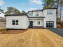 Modern two story home featuring a manicured lawn, attached garage, modern design, and lots of natural light at 3444 Underwood Se Ct, Conyers, GA 30013