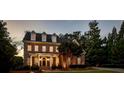 Elegant brick home with dormer windows and manicured lawn at 4992 Price Dr, Suwanee, GA 30024