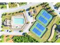 Overhead aerial view of a community pool and tennis courts next to tree-lined street at 1159 Fort Marcy Park, Lawrenceville, GA 30044