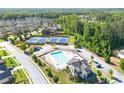 Aerial view of a community pool and tennis courts surrounded by lush trees at 1159 Fort Marcy Park, Lawrenceville, GA 30044