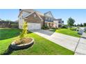 Two-story brick home featuring a two-car garage and well-maintained front yard at 1159 Fort Marcy Park, Lawrenceville, GA 30044