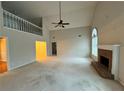 Bright living area with a brick fireplace and ample space, highlighted by a ceiling fan at 2020 Wynfield Point Dr, Buford, GA 30519