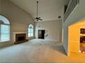 Spacious living room with a fireplace and soaring ceilings, bathed in natural light at 2020 Wynfield Point Dr, Buford, GA 30519