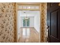 Welcoming foyer with hardwood floors, chandelier, and floral wallpaper at 4100 Paces Se Walk # 3205, Atlanta, GA 30339