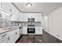 Modern kitchen featuring stainless steel appliances, granite countertops and a stylish backsplash at 374 Lamancha Ct, Lawrenceville, GA 30044