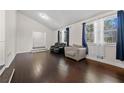 Spacious living area with hardwood floors and plenty of natural light from large windows at 374 Lamancha Ct, Lawrenceville, GA 30044