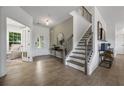 Inviting foyer with wood floors, staircase, and stylish decor, showcasing a bright and open entrance at 371 Foxglove Way, Mcdonough, GA 30253