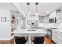 Modern kitchen with stainless steel appliances, white cabinetry, and a large center island at 1309 Arnold Ne Ave, Atlanta, GA 30324