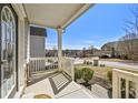 Inviting front porch offers a pleasant view of the neighborhood with white railings and ample sunlight at 1566 Wilson Manor Cir, Lawrenceville, GA 30045
