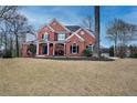 Inviting two-story brick home with manicured lawn and covered front porch at 3534 Brandywine Nw Rd, Kennesaw, GA 30144