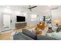 Modern open concept living space featuring a sleek entertainment center and hardwood flooring at 383 Pratt Se Dr # 503, Atlanta, GA 30315