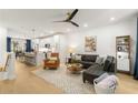 Bright open concept living area with modern decor and hardwood floors flowing into the kitchen at 383 Pratt Se Dr # 503, Atlanta, GA 30315
